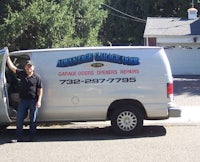 a man standing next to a van in front of a house